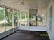 View of a screened porch with a ceiling fan looking out to the backyard at 7224 Ryman Loop, Zephyrhills, FL 33540