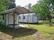 View of the backyard showing a shed with a covered area at 7224 Ryman Loop, Zephyrhills, FL 33540