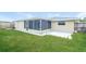 This backyard features a large lawn, screen room, and an extra patio space at 7405 Oakshire Dr, Port Richey, FL 34668