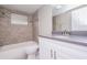 Bathroom with tiled shower, neutral paint, updated vanity and fixtures at 7405 Oakshire Dr, Port Richey, FL 34668