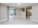 Bright living space with access to a screened patio and modern kitchen at 7405 Oakshire Dr, Port Richey, FL 34668