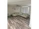 Spacious living room with hardwood flooring, featuring a plush sectional sofa and ceiling fan at 7525 Arbordale Dr, Port Richey, FL 34668