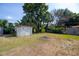 Large backyard with a storage shed, some trees, and a fire pit ready for entertaining at 7529 35Th N Ave, St Petersburg, FL 33710