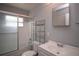 Well-lit bathroom featuring a shower-tub combo, shelving and modern fixtures at 7529 35Th N Ave, St Petersburg, FL 33710