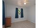 Bedroom featuring wood-look flooring, two windows with curtains, and a wooden dresser at 7529 35Th N Ave, St Petersburg, FL 33710