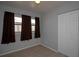A clean, simple bedroom with hardwood floors, a double closet, and three sunny windows at 7529 35Th N Ave, St Petersburg, FL 33710