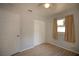Bright bedroom with ceiling fan, wood-look flooring, closet, and a white door at 7529 35Th N Ave, St Petersburg, FL 33710
