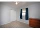 Cozy bedroom featuring a ceiling fan, gray walls, wood-look flooring and a window with blue curtains at 7529 35Th N Ave, St Petersburg, FL 33710