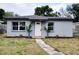 Charming gray home with a tidy front lawn and a welcoming front entrance at 7529 35Th N Ave, St Petersburg, FL 33710