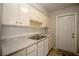 Bright kitchen features ample counter space, stainless steel sink, and white cabinetry at 7529 35Th N Ave, St Petersburg, FL 33710
