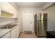 Kitchen features stainless steel refrigerator, range, sink, and white cabinetry at 7529 35Th N Ave, St Petersburg, FL 33710