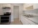 Bright kitchen features stainless steel appliances, light wood-look floors, and ample counter space at 7529 35Th N Ave, St Petersburg, FL 33710