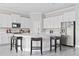 Modern kitchen with white cabinets, stainless steel appliances, and a large island at 7706 S Swoope St, Tampa, FL 33616