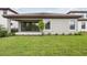 Expansive backyard with lush lawn, patio, and sliding glass doors for seamless indoor-outdoor living at 8514 Dove Bog Ter, Parrish, FL 34219