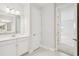 Bathroom featuring a double sink vanity, mirror, with an open door to another room at 8514 Dove Bog Ter, Parrish, FL 34219