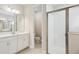 Bathroom featuring a double sink vanity, a toilet, and a glass-enclosed shower with white tiling at 8514 Dove Bog Ter, Parrish, FL 34219