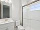 Modern bathroom featuring a glass-enclosed shower and a sleek vanity with ample lighting at 8514 Dove Bog Ter, Parrish, FL 34219