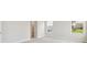 Spacious bedroom with carpet flooring, two windows, and a glimpse into the closet at 8514 Dove Bog Ter, Parrish, FL 34219