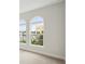 Bright bedroom featuring carpet, with modern arch windows bringing in natural light at 8514 Dove Bog Ter, Parrish, FL 34219