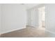 Bedroom with neutral carpet and white trim, featuring doorways and closet entrance at 8514 Dove Bog Ter, Parrish, FL 34219