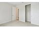 Bedroom with carpet, featuring closet and doorways to other rooms in the home at 8514 Dove Bog Ter, Parrish, FL 34219