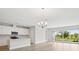Bright open kitchen and dining area featuring modern appliances and an island with backyard views at 8514 Dove Bog Ter, Parrish, FL 34219