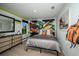 Playful bedroom features colorful accents, unique wall decor, and modern furnishings at 10009 Surrey Rose Dr, San Antonio, FL 33576