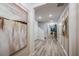 Inviting hallway with elegant wood flooring, decorative wall art, and a glimpse into the living area at 10009 Surrey Rose Dr, San Antonio, FL 33576