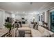 Open-concept living room with light wood flooring, neutral walls, and stylish furnishings at 10009 Surrey Rose Dr, San Antonio, FL 33576