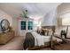 Main bedroom with geometric wallpaper, modern lighting, and plush bedding at 10009 Surrey Rose Dr, San Antonio, FL 33576