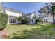 Spacious backyard with lush lawn and mature trees provides a serene outdoor space for recreation and relaxation at 1089 Virginia St, Dunedin, FL 34698