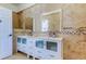 Bathroom featuring double sinks, patterned tile, and ample storage at 1089 Virginia St, Dunedin, FL 34698
