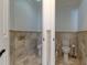 Modern bathrooms with private commodes and neutral-toned marble tiling at 1089 Virginia St, Dunedin, FL 34698