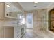 Elegant bathroom with marble countertops, modern fixtures, and a glass-enclosed shower at 1089 Virginia St, Dunedin, FL 34698