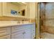 Stylish bathroom featuring travertine tile, a glass-enclosed shower, and a white vanity at 1089 Virginia St, Dunedin, FL 34698