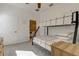 Bright bedroom featuring a bunk bed, adjacent bathroom, and stylish herringbone flooring at 1089 Virginia St, Dunedin, FL 34698