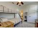 Bedroom featuring bunkbeds with ensuite bathroom and a ceiling fan at 1089 Virginia St, Dunedin, FL 34698