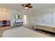 Spacious bedroom with a ceiling fan, an office nook, ensuite bathroom, and two beds at 1089 Virginia St, Dunedin, FL 34698