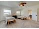 Bright bedroom features twin beds, bench seating, carpet floors, and a ceiling fan at 1089 Virginia St, Dunedin, FL 34698