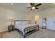 Comfortable bedroom with a metal bed frame, neutral decor, ceiling fan, and carpet floors at 1089 Virginia St, Dunedin, FL 34698