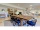 Open dining area with spacious table, modern chairs, and travertine flooring at 1089 Virginia St, Dunedin, FL 34698