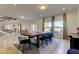 Dining room features large table with chairs and windows showing outdoor views at 1089 Virginia St, Dunedin, FL 34698