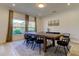 Dining room with an oversized table, large windows offering scenic views, and neutral decor at 1089 Virginia St, Dunedin, FL 34698