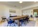 Dining room featuring a rustic wooden table, and views of a stylish living room at 1089 Virginia St, Dunedin, FL 34698