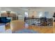 View of a light filled foyer with decorative wrought iron railing and a modern chandelier at 1089 Virginia St, Dunedin, FL 34698