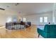 Grand foyer featuring a wrought iron railing, a statement chandelier, and gleaming wood floors at 1089 Virginia St, Dunedin, FL 34698