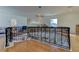 Elegant foyer showcasing wrought iron railing, a stunning chandelier, and gleaming wood floors at 1089 Virginia St, Dunedin, FL 34698