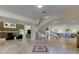 Grand foyer featuring a striking spiral staircase and travertine flooring at 1089 Virginia St, Dunedin, FL 34698