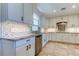 Elegant kitchen with stainless steel appliances, granite countertops, tile backsplash, and custom cabinets at 1089 Virginia St, Dunedin, FL 34698