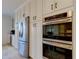 Kitchen featuring stainless steel refrigerator, double wall oven, and custom white cabinets at 1089 Virginia St, Dunedin, FL 34698